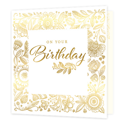 On your birthday - Formaat: Standaard - Vorm: Vierkant - Verjaardagskaart - Op deze kaart staat de tekst 'On your birthday' in het goud in een wit vierkant. Hierachter staan allerlei verschillende bloemen in een gouden kleur. - Snelwenskaart