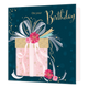 On your birthday - Formaat: Standaard - Vorm: Vierkant - Verjaardagskaart - Op deze kaart staat de tekst 'On your birthday' in het goud met daaronder een roze cadeau met een gouden deksel en roze met blauwe en gouden confetti en touwtjes. - Snelwenskaart