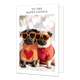 To the happy couple - Formaat: Standaard - Vorm: Staand - Huwelijkskaart - Op deze wenskaart staan twee hondjes in een trui met een groot hart erop. Op hun neus staat een oranje hartjes zonnebril. De afbeelding is omringd door een wit rader. Bovenin in het witte kader staat in het zwart de tekst 'To the happy couple'. - Snelwenskaart