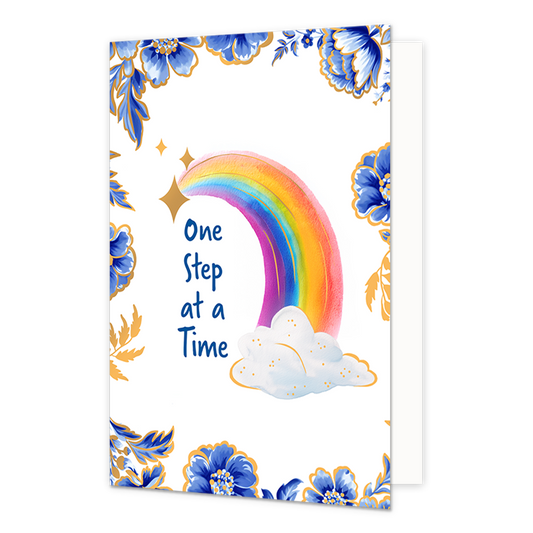 One step at a time - Formaat: Normaal - Vorm: Staand - Beterschapskaart - Op deze wenskaart staat centraal een kleurrijke regenboog afgebeeld die ontspringt uit een witte wolk met goudkleurige spikkels en omringd wordt door goudkleurige sterren. De hoeken en randen van de kaart zijn op een witte achtergrond rijkelijk versierd met grote blauwe bloemen en bladeren in Delfts blauwe stijl, afgewerkt met fijne goudkleurige details. Aan de linkerzijde van de regenboog staat in blauwe letters onder elkaar de teks