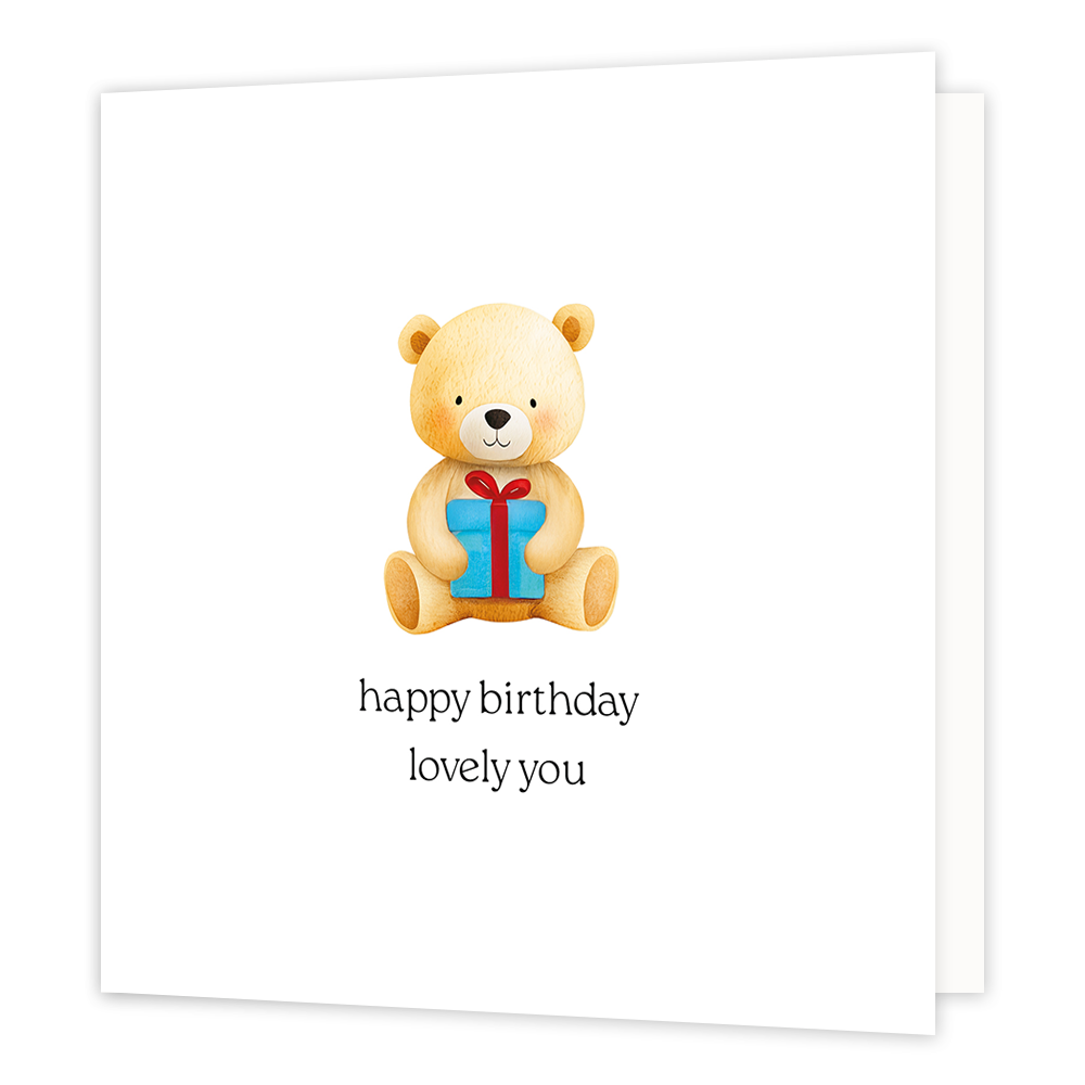 Happy birthday lovely you - Formaat: Klein - Vorm: Vierkant - Verjaardagskaart - Op deze wenskaart staat een getekende teddybeer afgebeeld die recht vooruit kijkt terwijl hij een blauw cadeautje met een rood lint vasthoudt. De beer is lichtbruin van kleur en zit op een witte achtergrond. Onder de illustratie staat de tekst "happy birthday lovely you" in zwarte letters. - Snelwenskaart