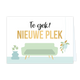 Te gek! Nieuwe plek - Formaat: Standaard - Vorm: Liggend - Woningkaart - Op deze wenskaart staat een lichte, pastelgroene bank afgebeeld tegen een witte achtergrond, met aan de linkerzijde een blauwe vaas met bloemen en aan de rechterzijde een hangplant in een macramé hanger. Boven de bank staat grote tekst gedrukt: bovenaan in cursieve, zwarte letters Te gek! en daaronder in grote, gouden hoofdletters NIEUWE PLEK. - Snelwenskaart