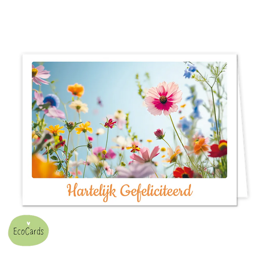 Hartelijk gefeliciteerd - Afmeting: {"value":13.4,"unit":"CENTIMETERS"} x {"value":9.7,"unit":"CENTIMETERS"} - Formaat: Klein - Vorm: Liggend - Felicitatiekaart - Op deze wenskaart staat een bloemenveld met de kleuren roze, blauw, geel, oranje, paars, rood en groen. Onder de illustratie staat de tekst: "Hartelijk gefeliciteerd". - Snelwenskaart