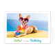 Aloha it's your birthday - Formaat: Klein - Vorm: Liggend - Verjaardagskaart - Op deze wenskaart staat een hond met een zonnenbril en bloemenslinger, die bij de zee ligt te zonnen. Onder de illustratie staat de tekst: "Aloha! It's your birthday". - Snelwenskaart