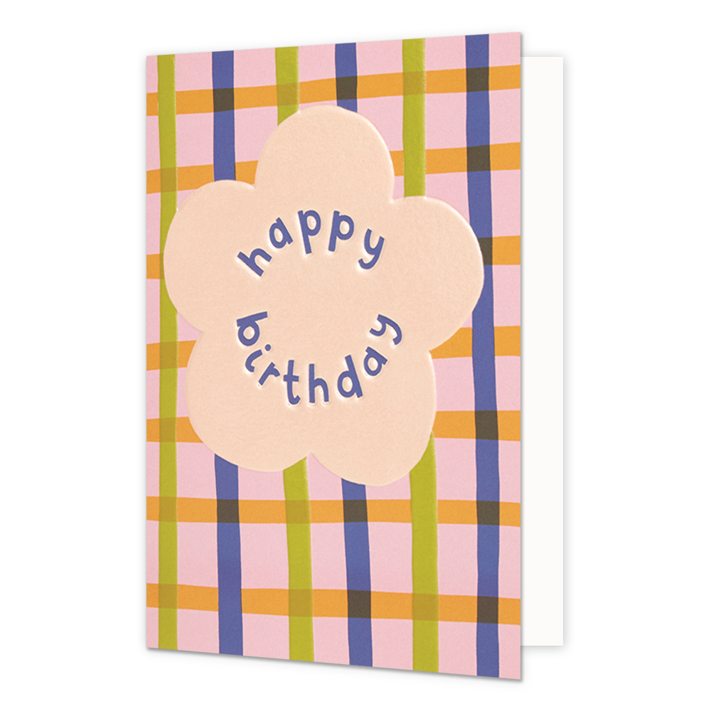 Happy birthday - Formaat: Normaal - Vorm: Staand - Verjaardagskaart - Op deze wenskaart staat in het midden een grote, lichtroze bloemvorm. Binnenin de bloem staat de tekst "happy birthday" in paarse, speelse letters die de ronde vorm van de bloem volgen. De achtergrond van de kaart bestaat uit een kleurrijk ruitpatroon met verticale en horizontale banen in de kleuren roze, geel, groen en paars. - Snelwenskaart