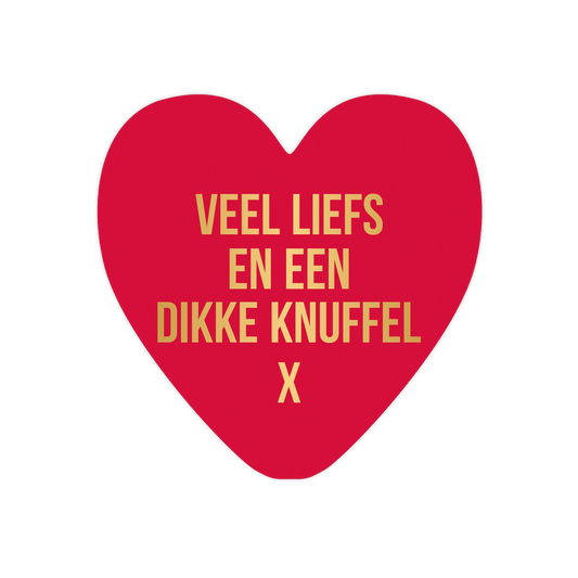 Veel liefs en een dikke knuffel - Formaat: Standaard - Vorm: Hart - Vriendschapskaart - Op deze harten wenskaart is een effen rode achtergrond te zien. Centraal staat de tekst "VEEL LIEFS EN EEN DIKKE KNUFFEL" in vier regels, gevolgd door een "X" op de laatste regel. De tekst is gedrukt in een strak, goudkleurig lettertype dat scherp afsteekt tegen de rode ondergrond. Het ontwerp is minimalistisch en krachtig door het gebruik van slechts twee kleuren. - Snelwenskaart