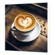 Cappuccino - Formaat: Standaard - Vorm: Vierkant - Blanco kaart - Op deze wenskaart staat een illustratie van een witte kop koffie met schuim op een bijbehorend schoteltje, geplaatst op een houten ondergrond. In het koffieschuim is met latte art een sierlijk hartpatroon aangebracht. Naast het kopje liggen verspreid verschillende koffiebonen. Er is geen tekst op de illustratie zichtbaar. - Snelwenskaart