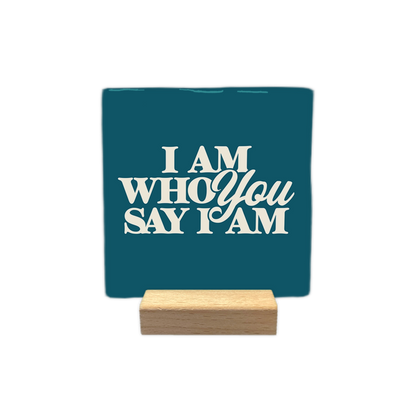 I am who you say I am - Decoratie tegel - Formaat: - Op deze decoratie tegel staat de tekst "I am who you say I am" in crèmekleurige letters. De woorden zijn gestapeld en gecentreerd op een diepblauwe achtergrond. Het lettertype heeft een klassieke en stijlvolle uitstraling. - Snelwenskaart