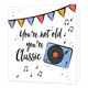 You're not old you're classic - Formaat: Standaard - Vorm: Vierkant - Verjaardagskaart - Op deze wenskaart staan slingers met een platenspeler en de tekst: "You're not old you're classic". - Snelwenskaart