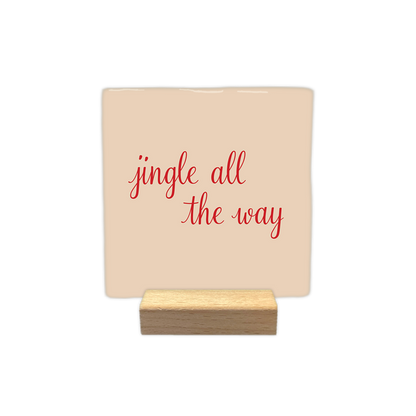 Jingle all the way - Decoratie tegel - Formaat: - Op deze decoratie tegel staat een lichte achtergrond met in het midden de tekst jingle all the way in rode handgeschreven letters. - Snelwenskaart