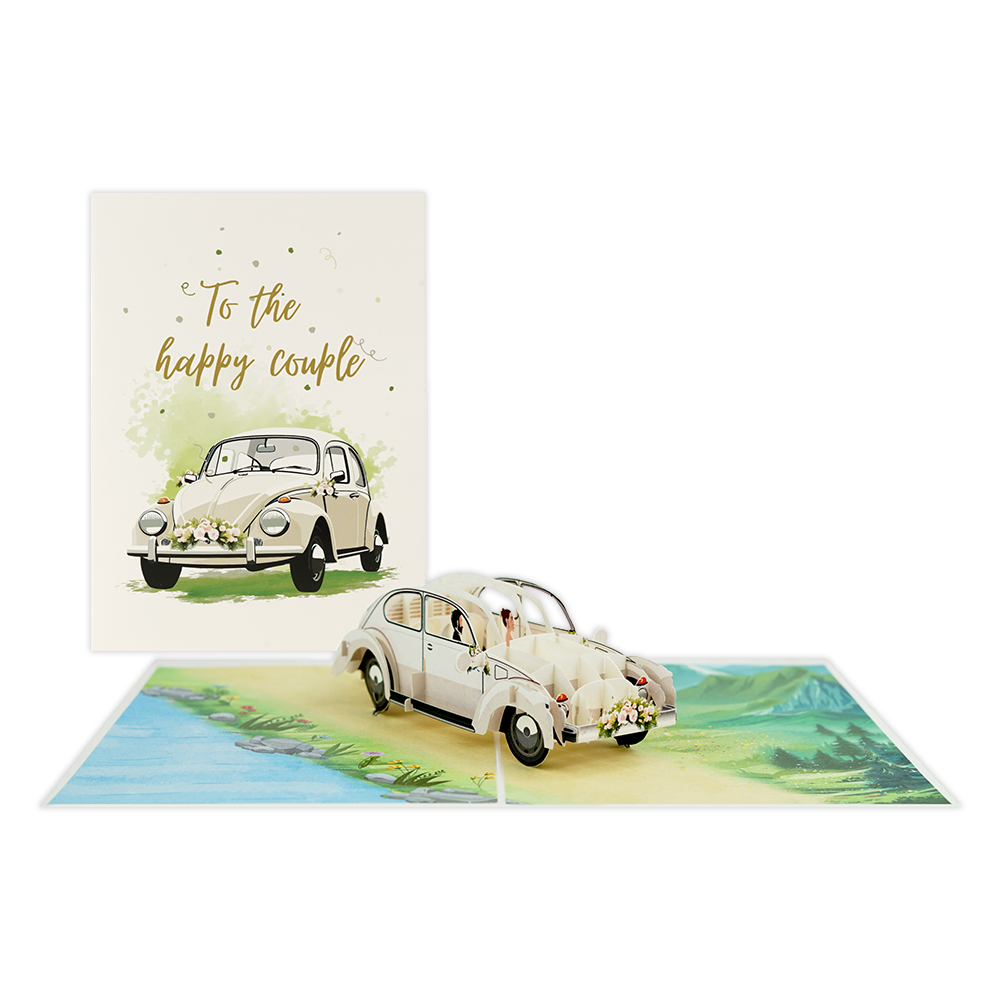 To the happy couple - Formaat: Standaard - Vorm: Staand - Huwelijkskaart - Op deze wenskaart staat een witte trouwauto met daarboven de tekst: "To the happy couple". - Snelwenskaart