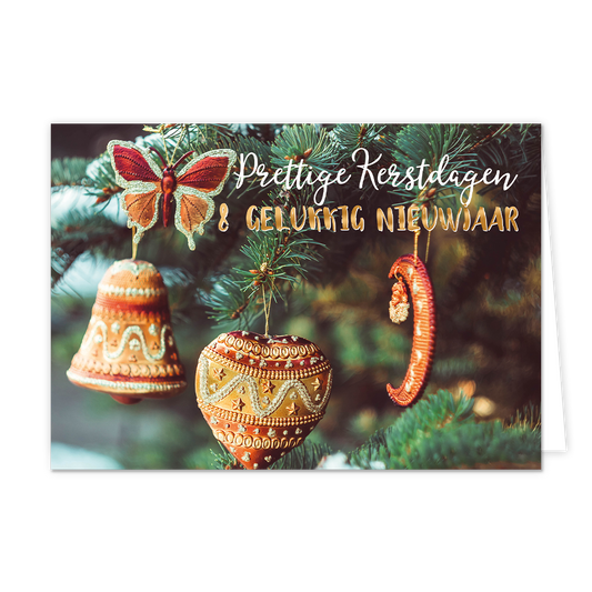 Op deze wenskaart hangen diverse warme, goud- en koperkleurige ornamenten, waaronder een vlinder, een klok, een hart en een halve maan, aan de takken van een kerstboom. De ornamenten zijn gedetailleerd versierd met patronen en glitters die oplichten tegen de groene naalden van de boom. Rechtsboven staat de tekst "Prettige Kerstdagen" in een wit sierlijk handschrift, met daaronder "& GELUKKIG NIEUWJAAR" in glanzende gouden blokletters.