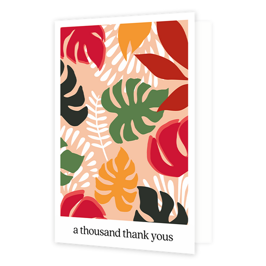 A thousand thank yous - Formaat: Normaal - Vorm: Staand - Bedankkaart - Op deze wenskaart staan bladeren in de kleuren groen, wit, rood, oranje en zwart. Onder de illustratie staat de tekst: "A thousand thank yous". - Snelwenskaart