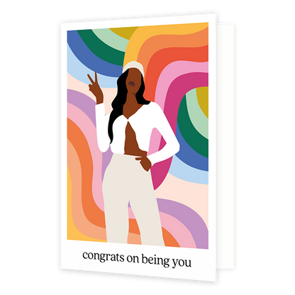 Congrats on being you - Formaat: Standaard - Vorm: Staand - Felicitatiekaart - Op deze wenskaart staat een vrouw die een peace teken maakt met haar vingers, op een achtergrond met lijnen in de kleuren oranje, geel, rood, roze, groen. blauw, paars en wit. Over de illustratie staat: "Congrats on being you". - Snelwenskaart