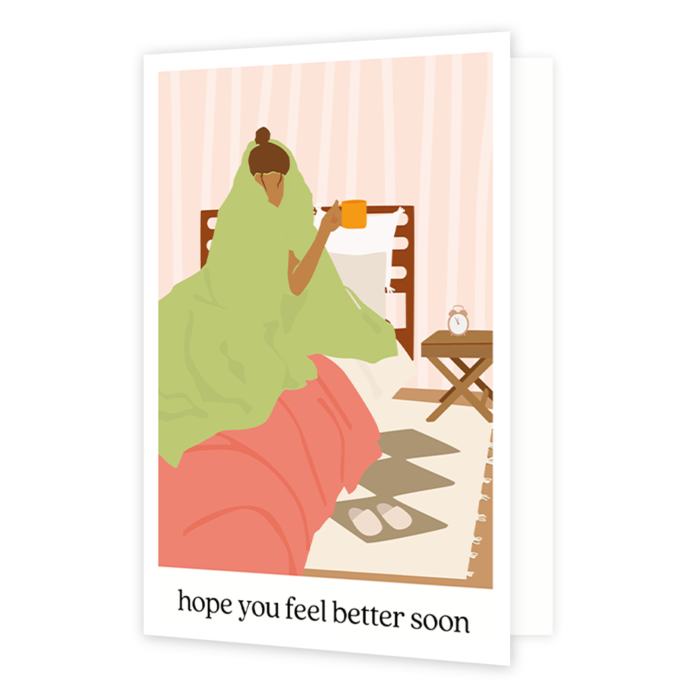 Hope you feel better soon - Formaat: Standaard - Vorm: Staand - Beterschapskaart - Op deze wenskaart staat een vrouw die in bed ligt met een deken over haar heen en een mok in de hand. Onder de illustratie staat de tekst: "Hope you feel better soon". - Snelwenskaart