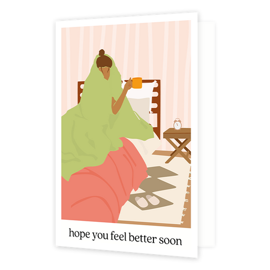 Hope you feel better soon - Formaat: Normaal - Vorm: Staand - Beterschapskaart - Op deze wenskaart staat een vrouw die in bed ligt met een deken over haar heen en een mok in de hand. Onder de illustratie staat de tekst: "Hope you feel better soon". - Snelwenskaart