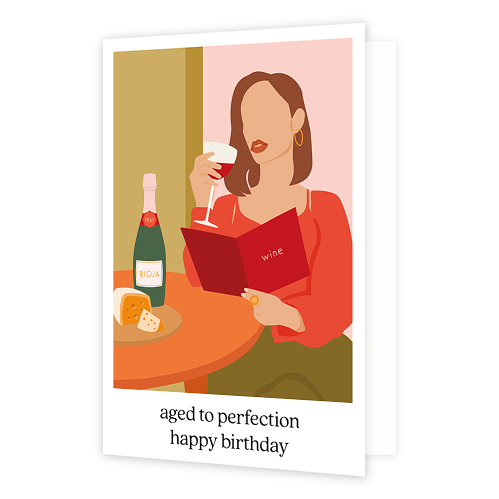 Aged to perfection happy birthday - Formaat: Standaard - Vorm: Staand - Verjaardagskaart - Op deze wenskaart staat een vrouw die een glas rode wijn drinkt terwijl ze op de wijnkaart kijkt. Onder de illustratie staat de tekst: "Aged to perfection happy birthday". - Snelwenskaart