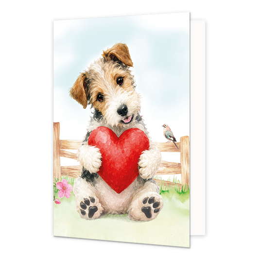 Hond met rood hart - Formaat: Standaard - Vorm: Staand - Liefdeskaart - Op deze wenskaart staat een aquarelillustratie van een schattige, ruwharige puppy die met zijn voorpoten een groot, rood hart vasthoudt. De hond zit voor een houten hek in een grasveld met bloemen, waarbij een klein vogeltje op het hek naast hem rust. De puppy kijkt met een zachte, vrolijke uitdrukking omhoog tegen een lichte achtergrond. - Snelwenskaart