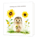 Sending you a little sunshine - Formaat: Groot - Vorm: Vierkant - Denken aan kaart - Op deze wenskaart staat een schattige egeltje afgebeeld op een witte achtergrond, dat in zijn pootjes een klein boeketje gele bloemen vasthoudt. Het egeltje staat in het gras en is omringd door grote zonnebloemen en kleinere gele bloemetjes in een aquarel-stijl. Bovenaan de afbeelding staat in bruine letters de tekst sending you a little sunshine. - Snelwenskaart