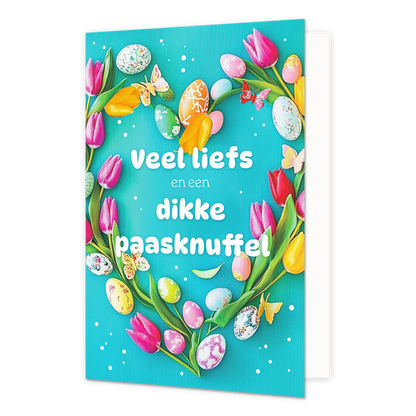 Veel liefs en een dikke paasknuffel - Formaat: Normaal - Vorm: Staand - Paaskaart - Op deze paaskaart staat een hartje gemaakt van bloemen en eitjes met in het midden de tekst: "Veel liefs en een dikke paasknuffel". - Snelwenskaart