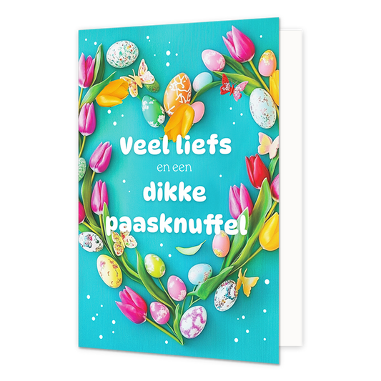 Veel liefs en een dikke paasknuffel - Formaat: Normaal - Vorm: Staand - Paaskaart - Op deze paaskaart staat een hartje gemaakt van bloemen en eitjes met in het midden de tekst: "Veel liefs en een dikke paasknuffel". - Snelwenskaart