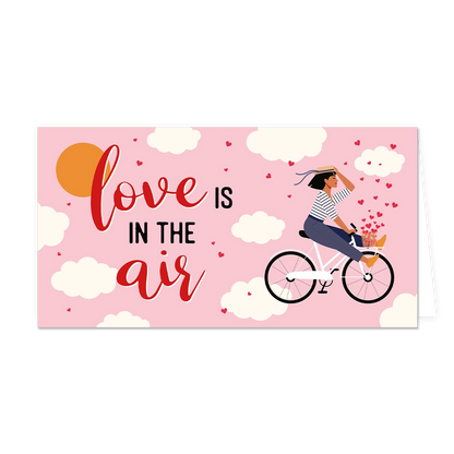 Love is in the air - Formaat: Groot - Vorm: Liggend - Valentijnskaart - Op deze wenskaart staat een vrouw op een fiets, omringt door wolken met daarnaast de tekst: "Love is in the air". - Snelwenskaart