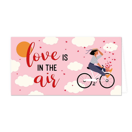 Love is in the air - Formaat: Groot - Vorm: Liggend - Valentijnskaart - Op deze wenskaart staat een vrouw op een fiets, omringt door wolken met daarnaast de tekst: "Love is in the air". - Snelwenskaart