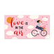 Love is in the air - Formaat: Groot - Vorm: Liggend - Valentijnskaart - Op deze wenskaart staat een vrouw op een fiets, omringt door wolken met daarnaast de tekst: "Love is in the air". - Snelwenskaart