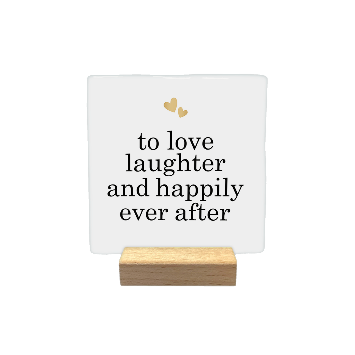 Decoratietegel – 10 x 10 cm - Op deze decoratietegel staat de tekst "shit just got real" in zwarte letters met een klassiek schreeflettertype. Boven de tekst zijn twee in elkaar grijpende trouwringen afgebeeld, met daarboven een klein, handgetekend rood hartje. 