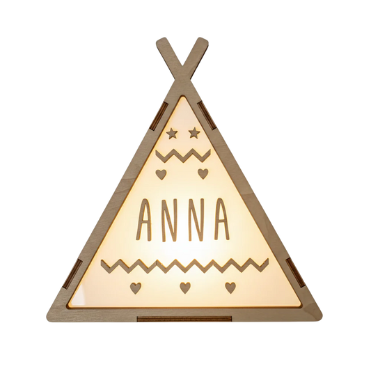 Op deze lamp staat een houten tipi-tent afgebeeld met een warme, oplichtende driehoekige voorzijde. Bovenin de lamp zijn twee sterretjes en twee kleine hartjes te zien, met daaronder een naam in houten letters. Onder de naam bevindt zich een zigzaggend patroon en drie kleine hartjes.