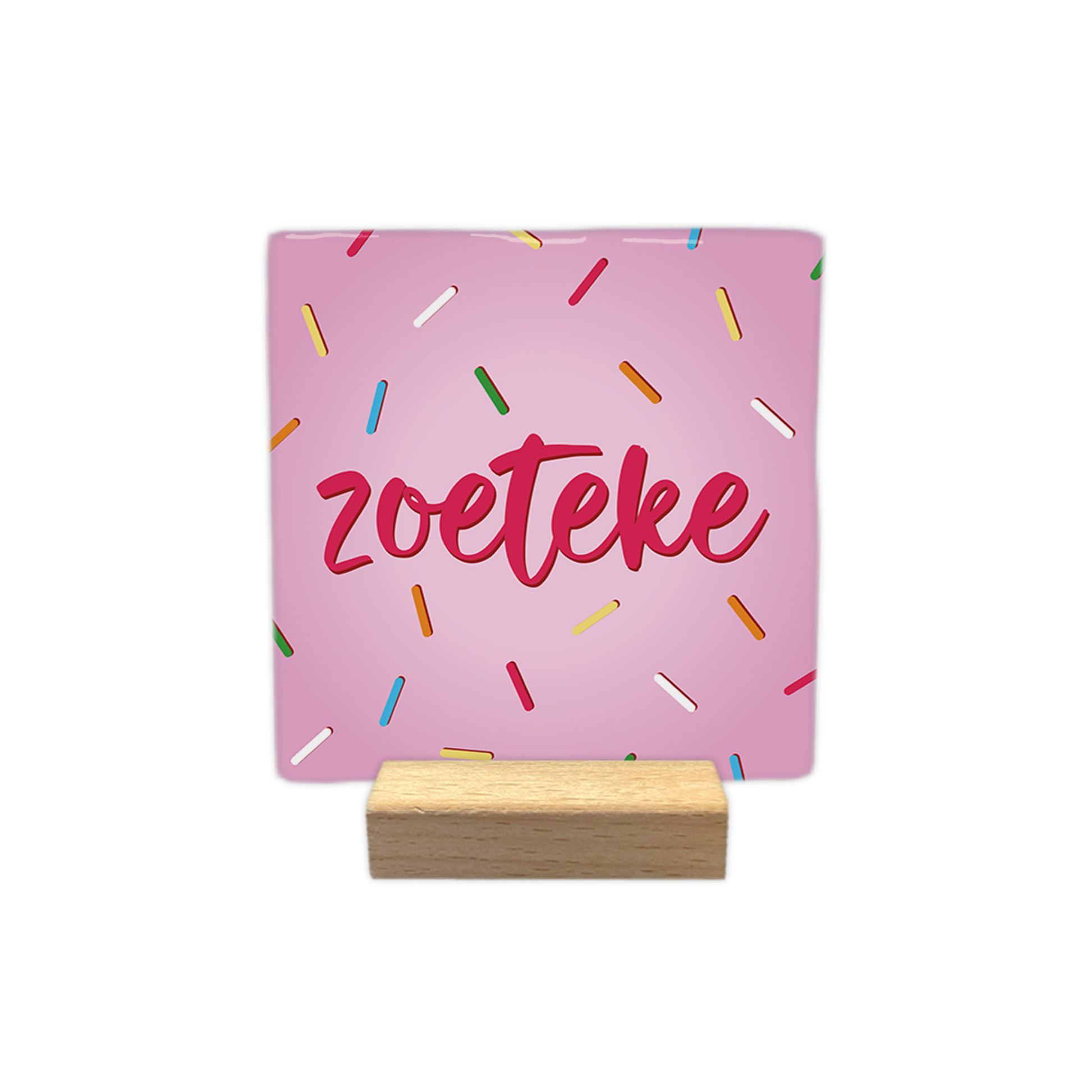 Zoeteke - Decoratie tegel - Formaat: - Op deze decoratie tegel staat het woord "zoeteke" centraal afgebeeld in roze, handgeschreven letters. De achtergrond van de tegel is lichtroze en is versierd met een patroon van kleine, gekleurde staafjes die doen denken aan spikkels. - Snelwenskaart