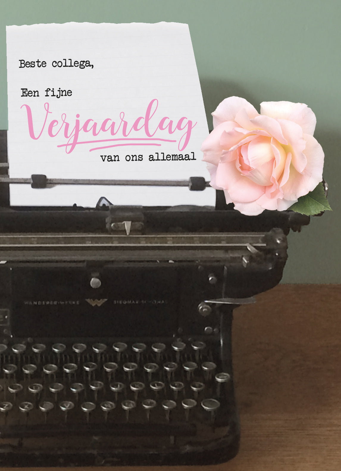 Op deze wenskaart staat een zwarte typmachine waar een blaadje zit met de tekst: "Beste collega, een fijne verjaardag van ons allemaal".